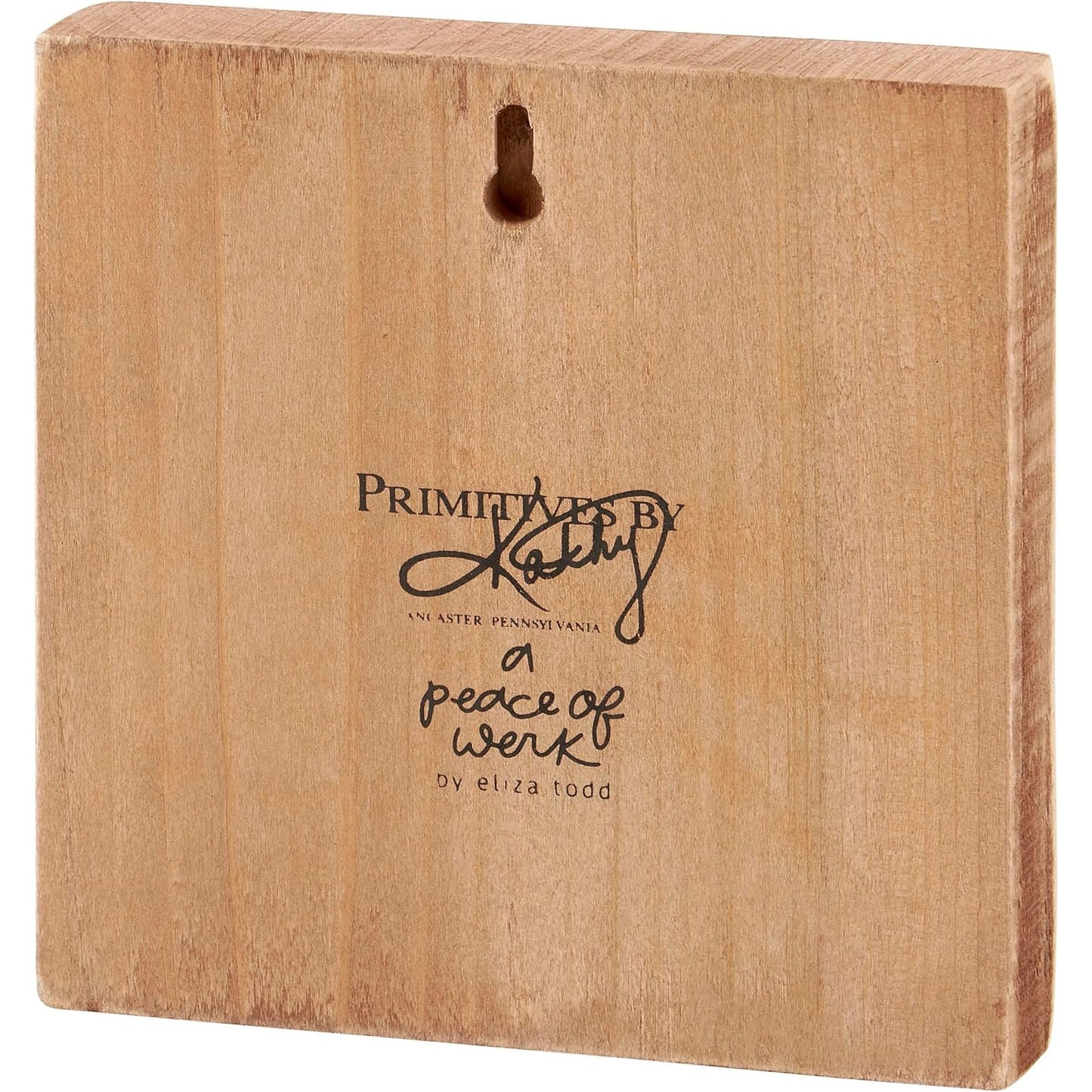 Wooden block with 'Primitives by Kathy' logo