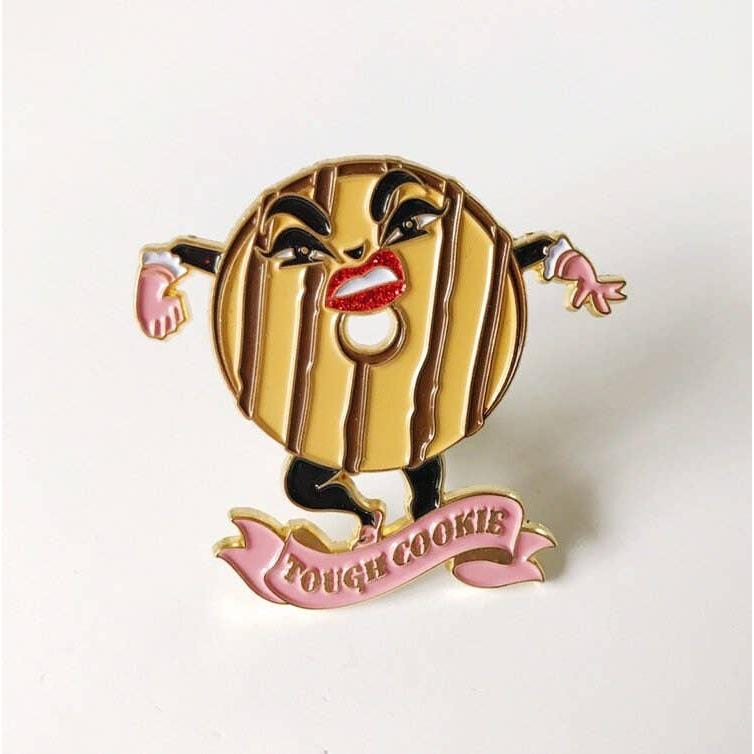 Gold cookie character with a red lip and 'Tough Cookie' banner on a white background
