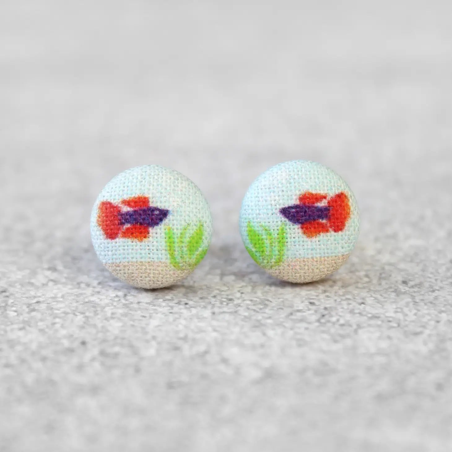 http://shop.getbullish.com/cdn/shop/products/Purple-Orange-Beta-Fish-Fabric-Button-Earrings-Handmade-in-the-US.webp?v=1674423231