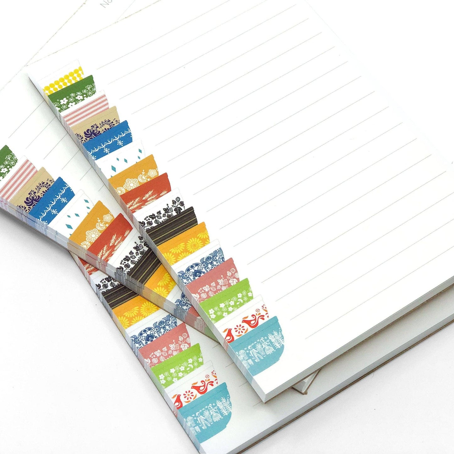 Colorful notepads with Pyrex-inspired design on a white background