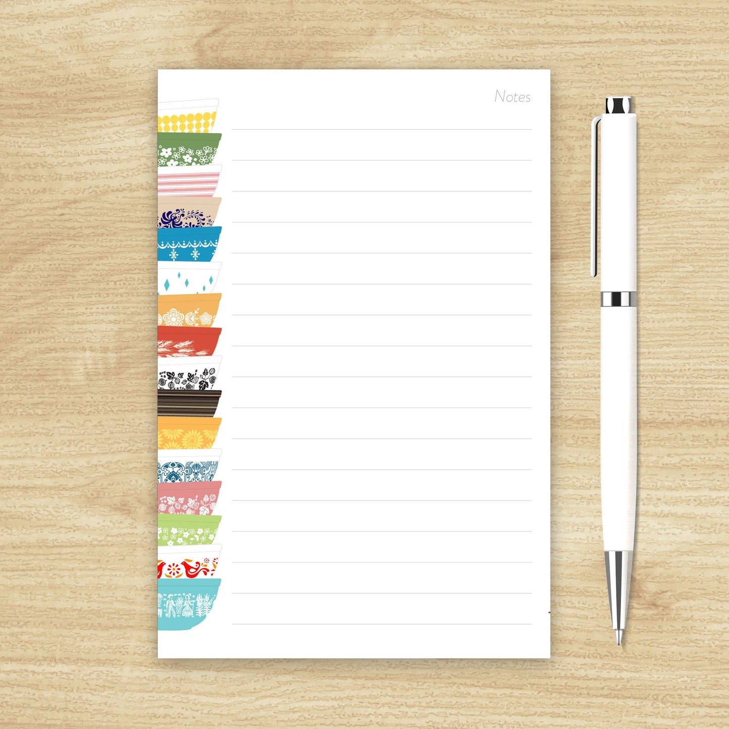 Colorful notepad with a pen on a wooden surface