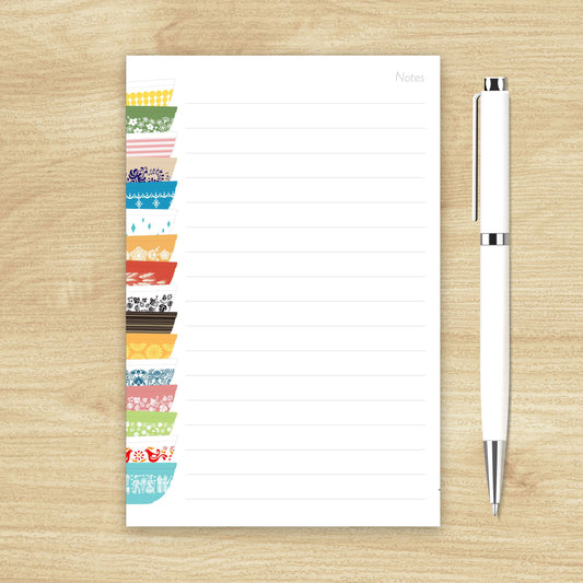Colorful notepad with a pen on a wooden surface