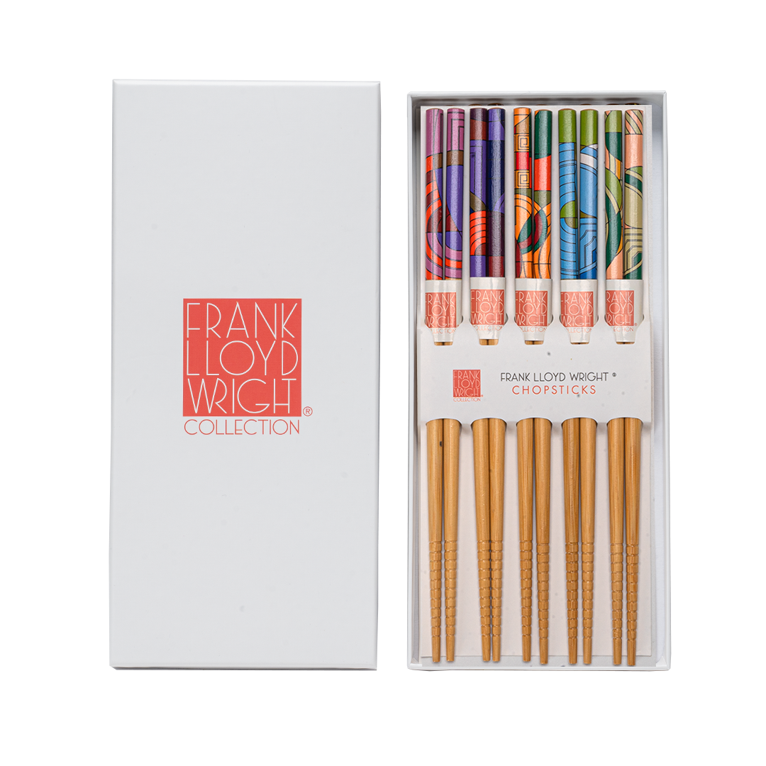 Frank Lloyd Wright Chopsticks Collection set, featuring a white presentation box with the brand logo and a clear tray displaying five colorful patterned chopsticks with natural bamboo handles.