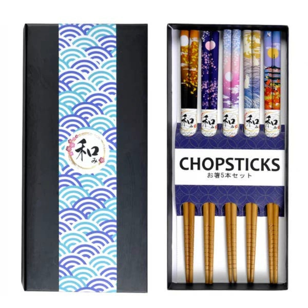 A boxed set of five Japanese chopsticks displayed next to its packaging box. The chopsticks feature various colorful traditional patterns (waves, cherry blossoms, pagodas) on the upper shafts and natural golden-brown wood on the handles.