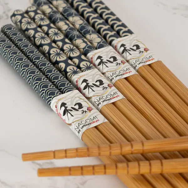 Set of wooden chopsticks with decorative wraps and Nagomi branding 