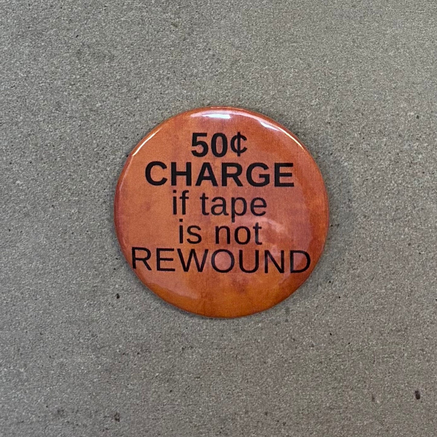 50 Cent Charge If Tape is Not Rewound Metal Pinbacked Button | 2.25" Large '80s Retro Button