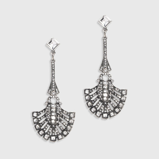 Pair of silver earrings with intricate designs on a light gray background