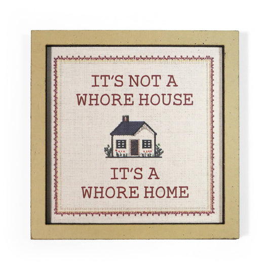 Decorative magnet with text 'It's not a whore house, it's a whore home' and a small house illustration.