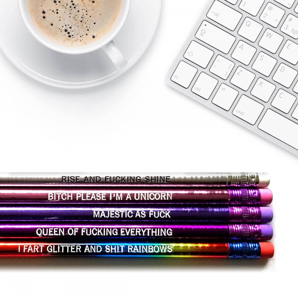 Five rainbow pencils with humorous text are arranged horizontally on a white surface
