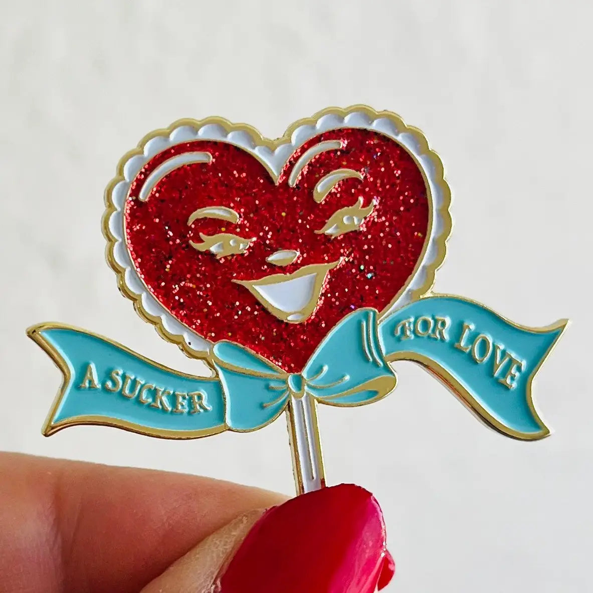 A Sucker For Love Soft Enamel Pin | Heart-Shaped Lollipop with Red Glitter-Kitschy Delish-The Bullish Store