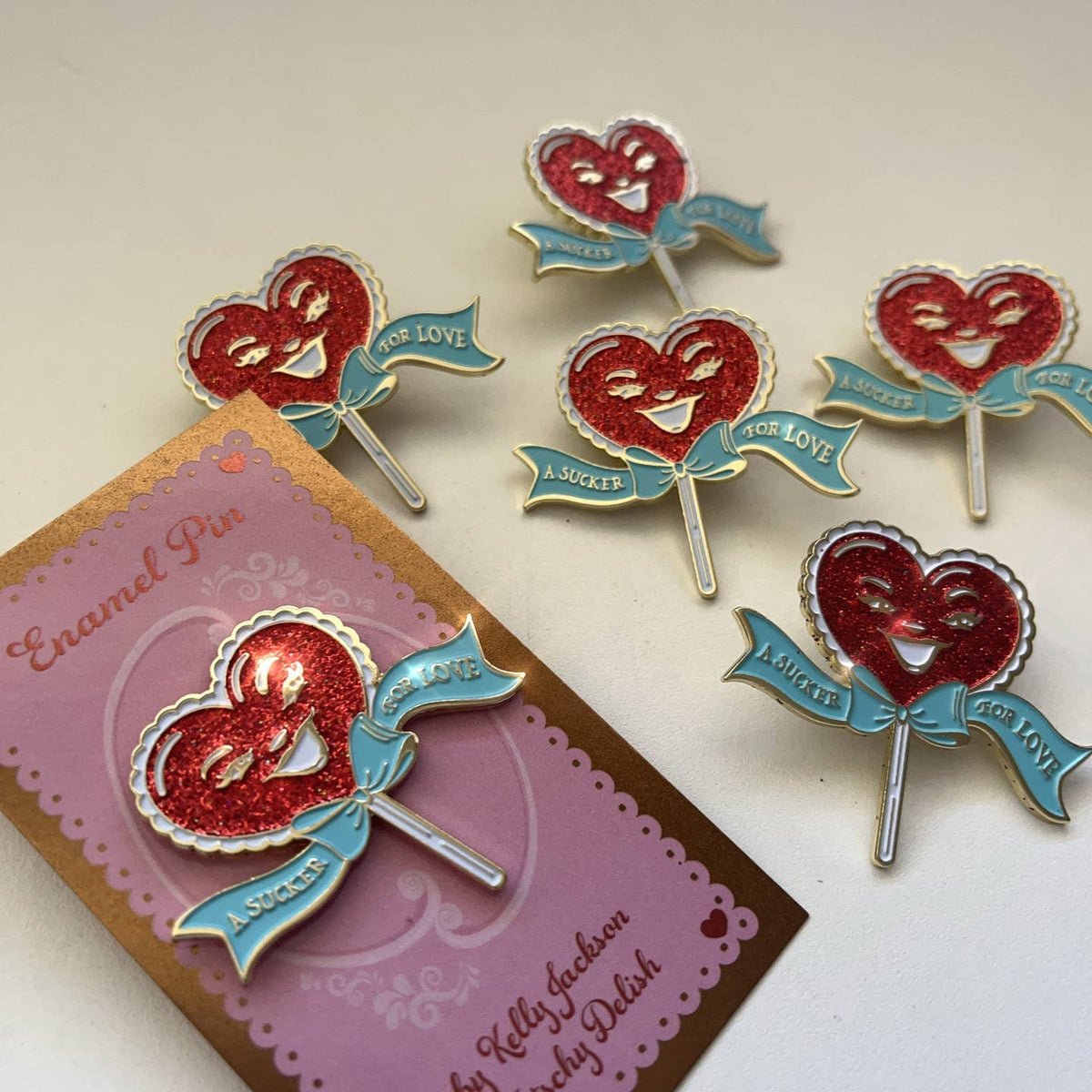 A Sucker For Love Soft Enamel Pin | Heart-Shaped Lollipop with Red Glitter-Kitschy Delish-The Bullish Store
