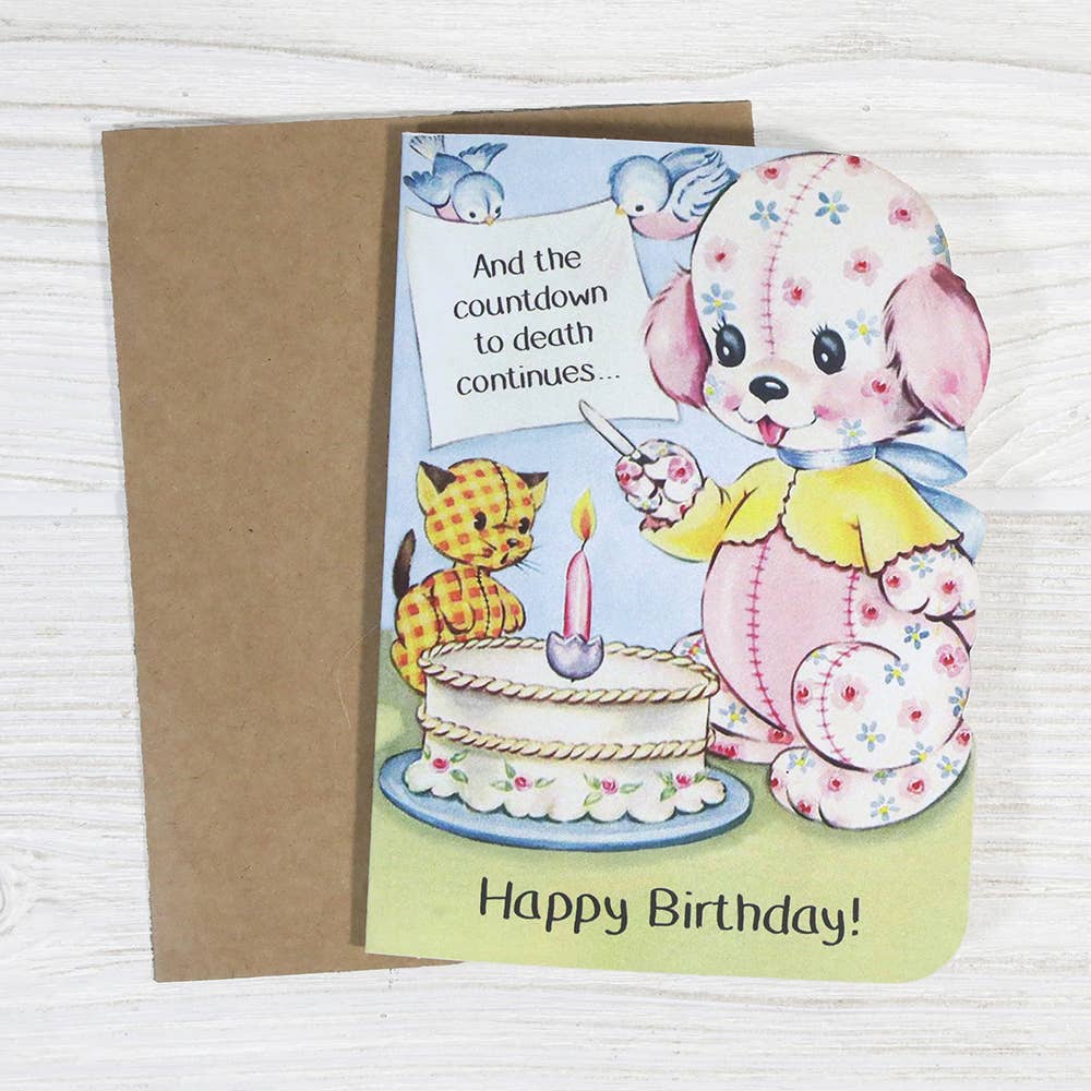 Birthday card with cartoon dog and cat by a cake, on a white background