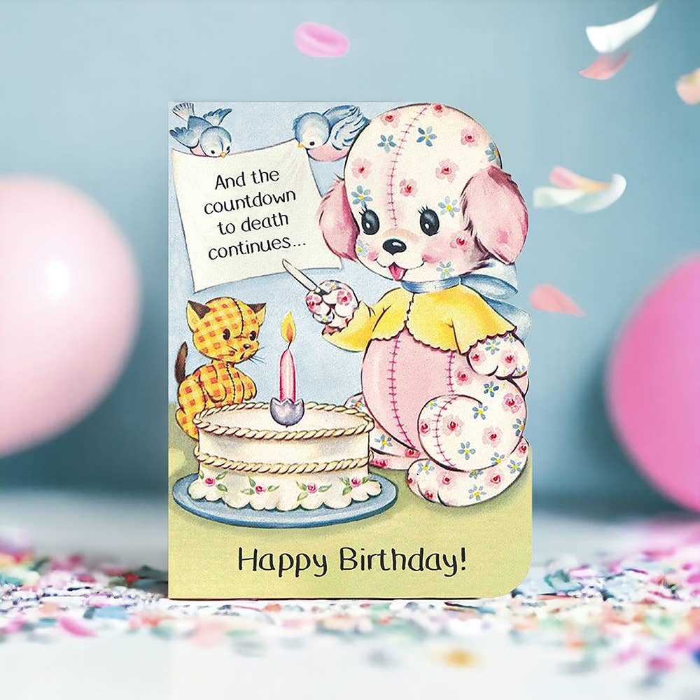 Birthday card with cartoon dog and cat by a cake, surrounded by balloons and confetti.
