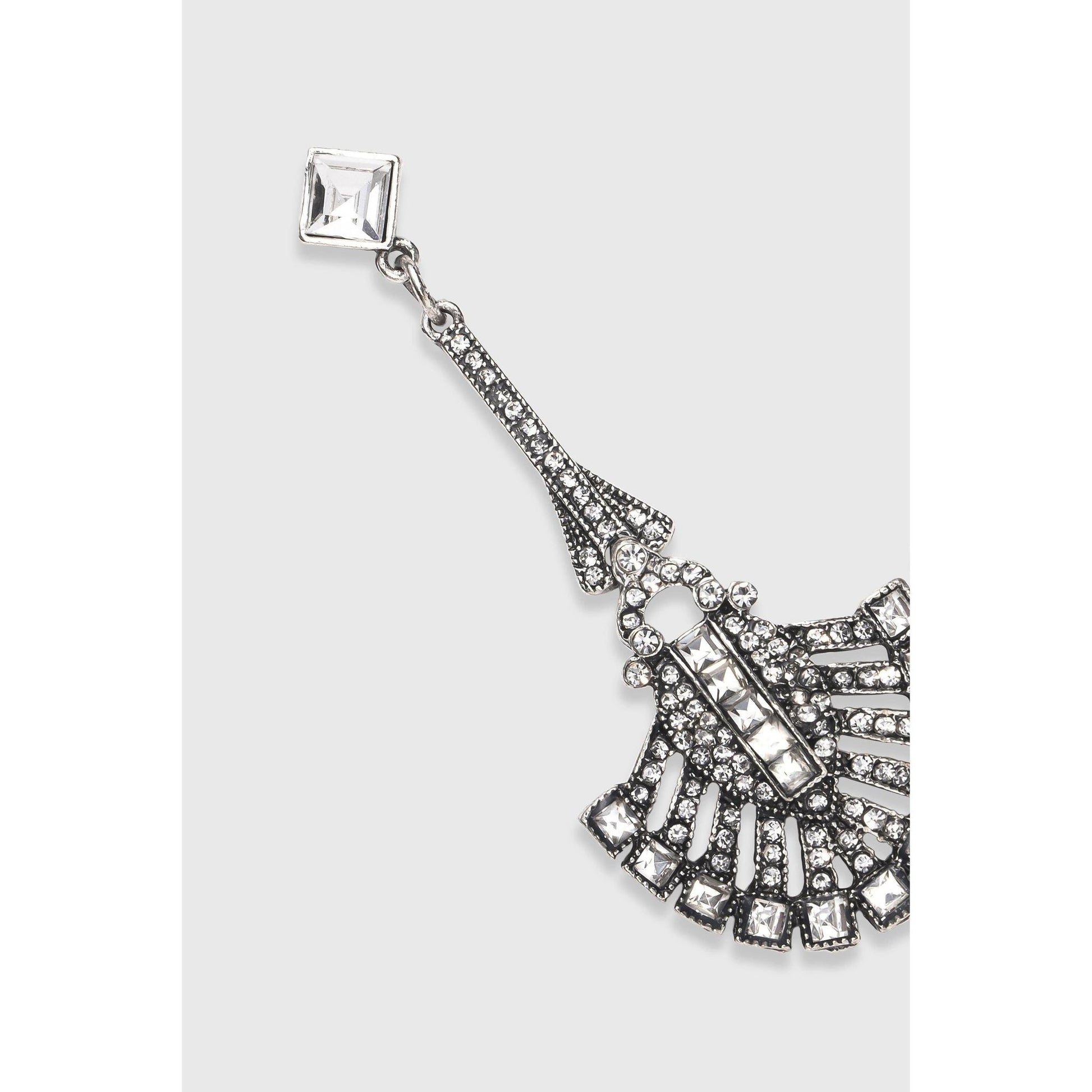 Decorative earrings with fan design and gemstones on a white background