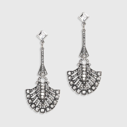 Pair of silver earrings with intricate designs on a light gray background