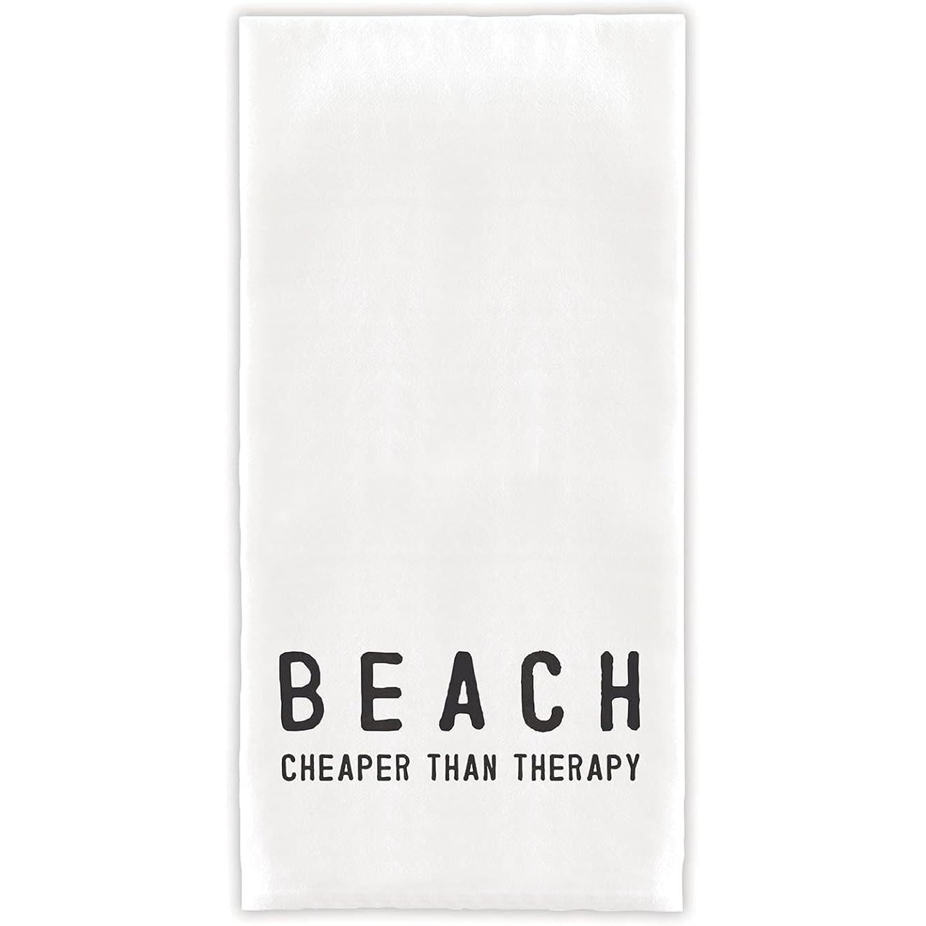 White towel with black text 'BEACH CHEAPER THAN THERAPY' on a white background