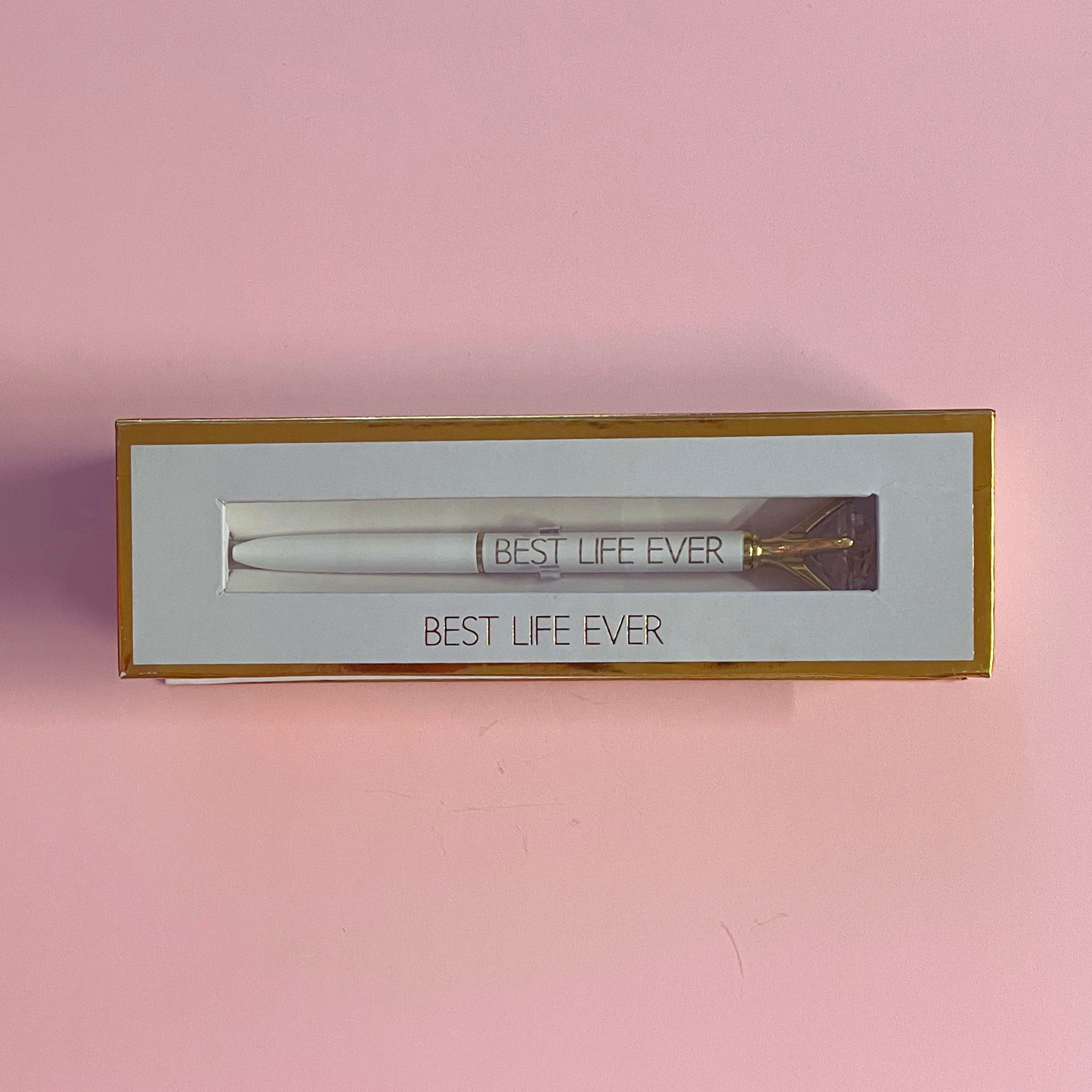 Pen with 'Best Life Ever' text in a box on a pink background