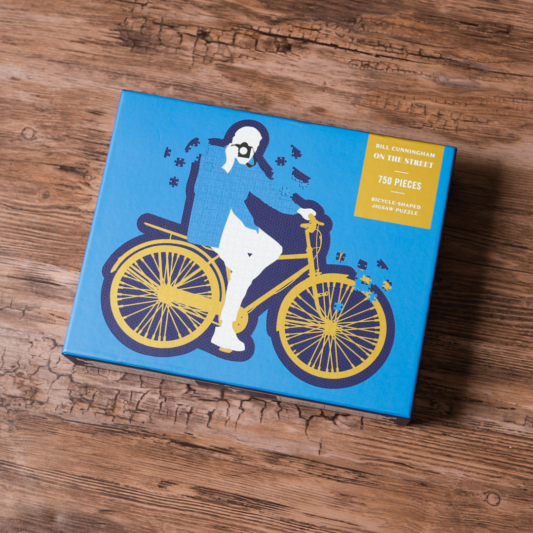 Blue box with a bicycle illustration on a wooden surface