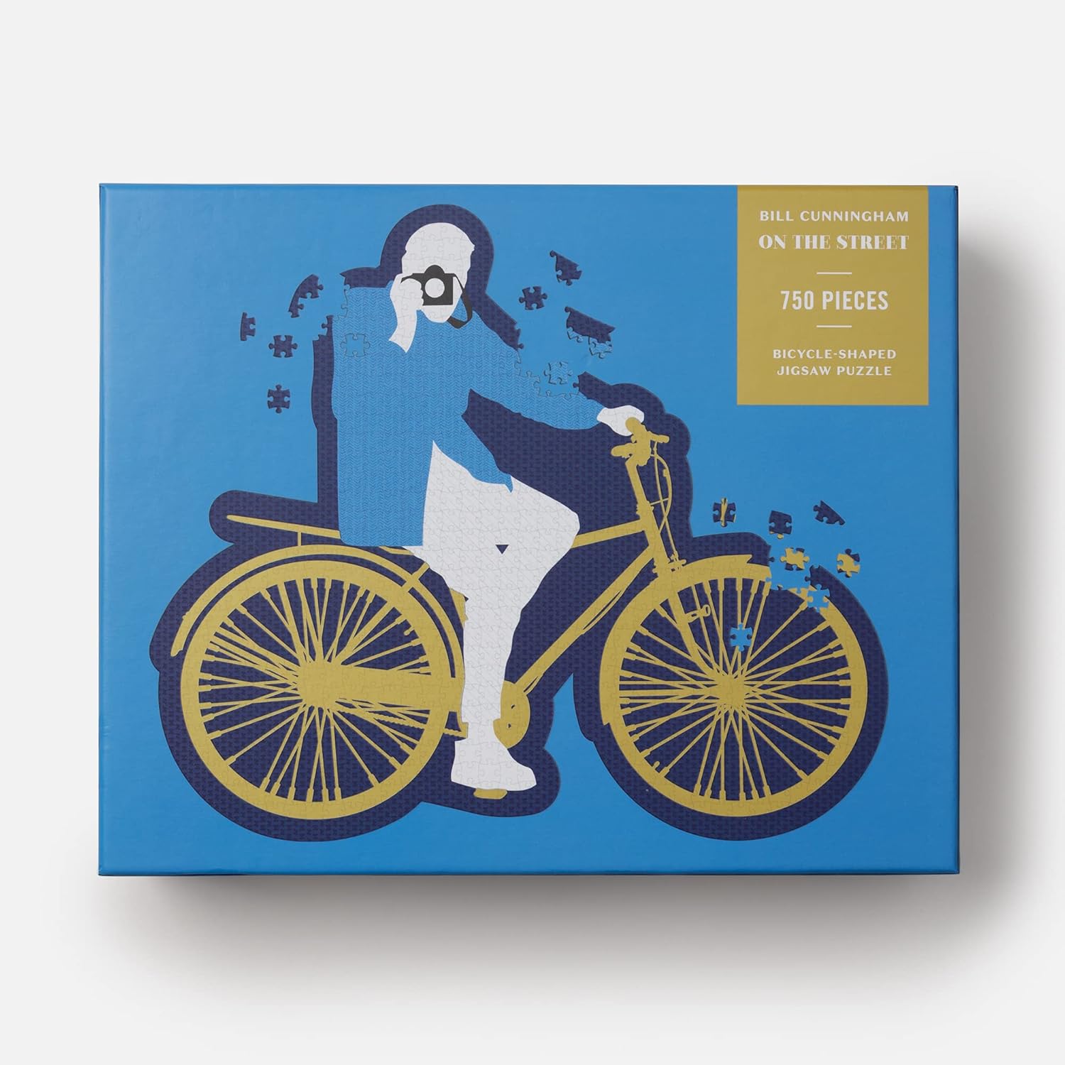 Jigsaw puzzle box with bicycle and person design on a blue background