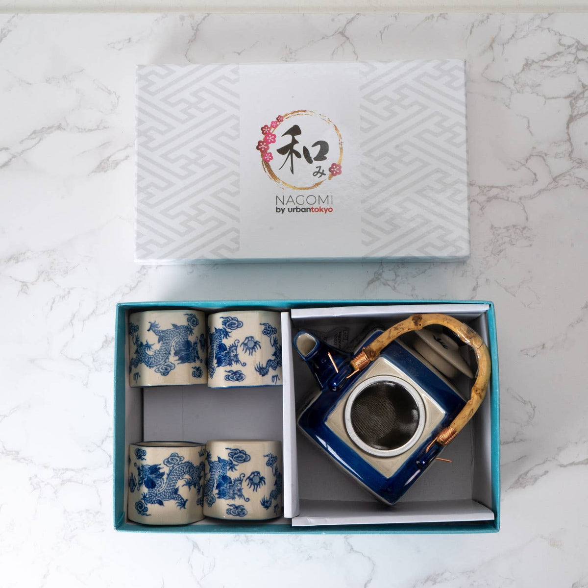 Ceramic tea set with blue floral patterns in a box