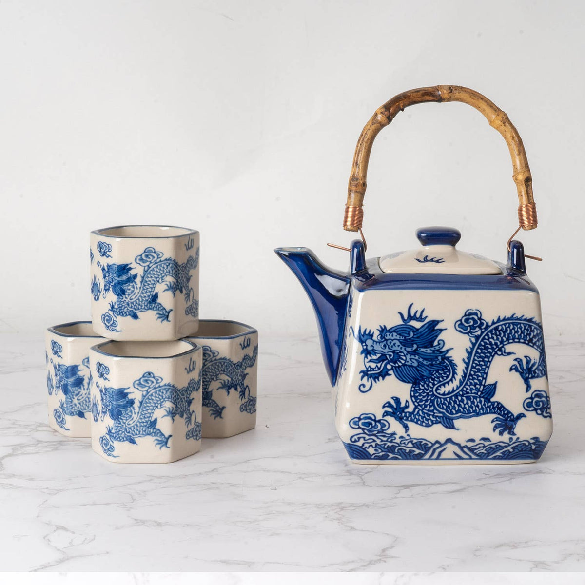 Ceramic teapot and cups with blue dragon design