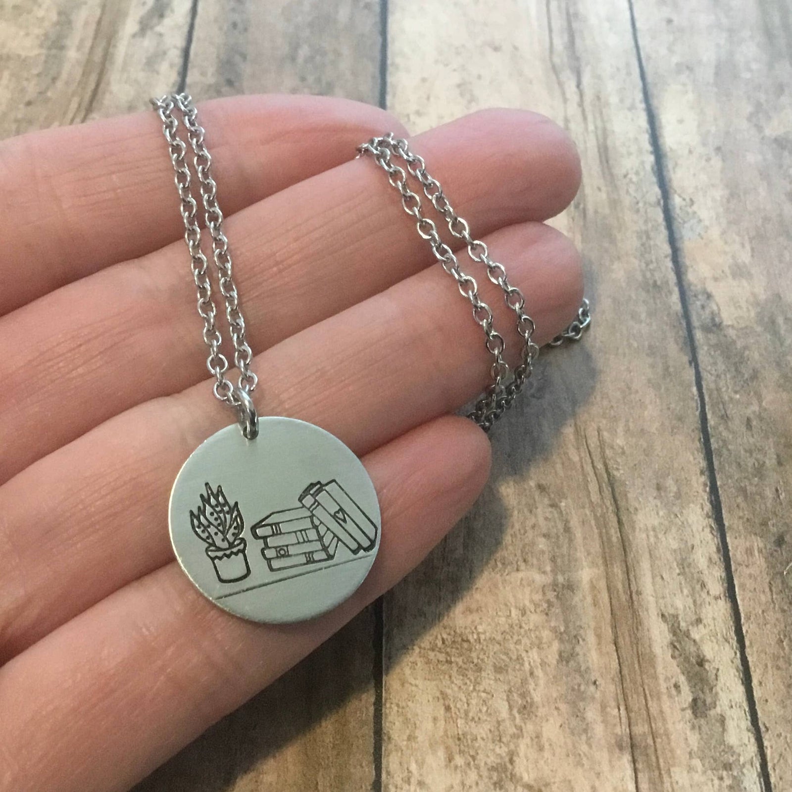 Books & Plants Handmade Necklace | Stack of Books with Plant Circular Stamped Pendant Necklace in Silver