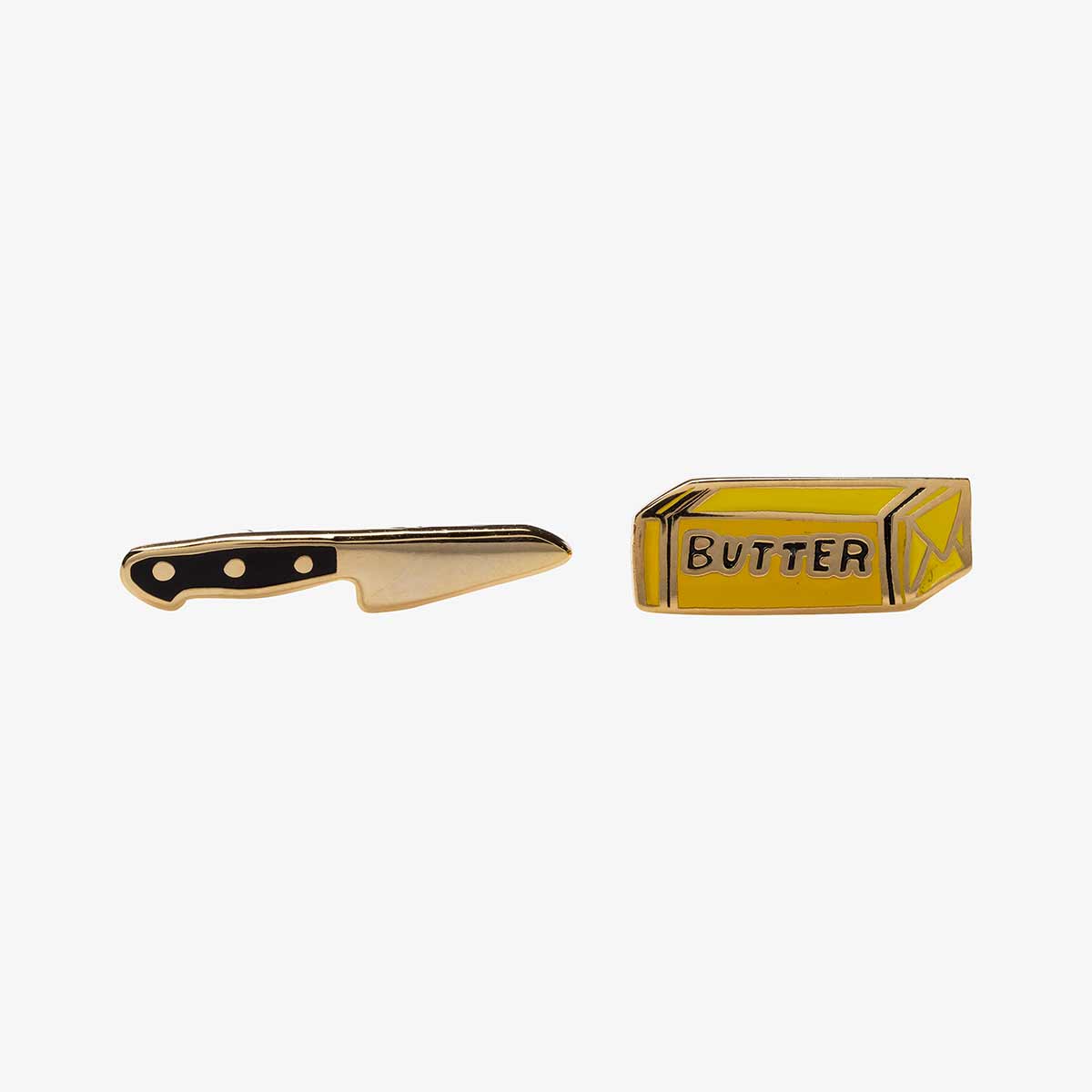 Gold butter knife and butter container earrings on a white background