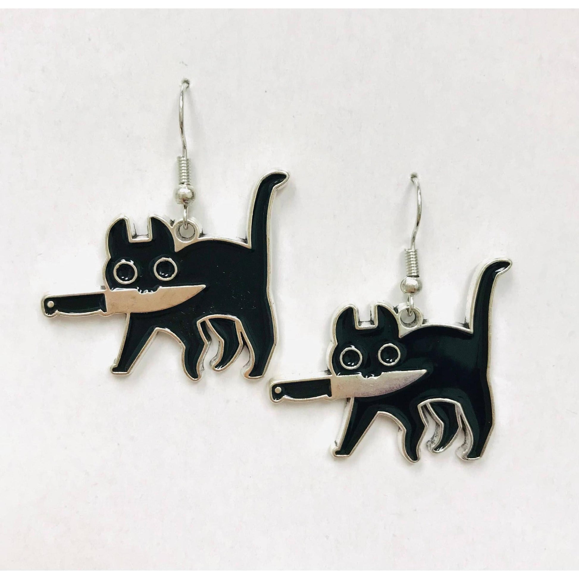 Black cat-shaped earrings holding a knife with its mouth