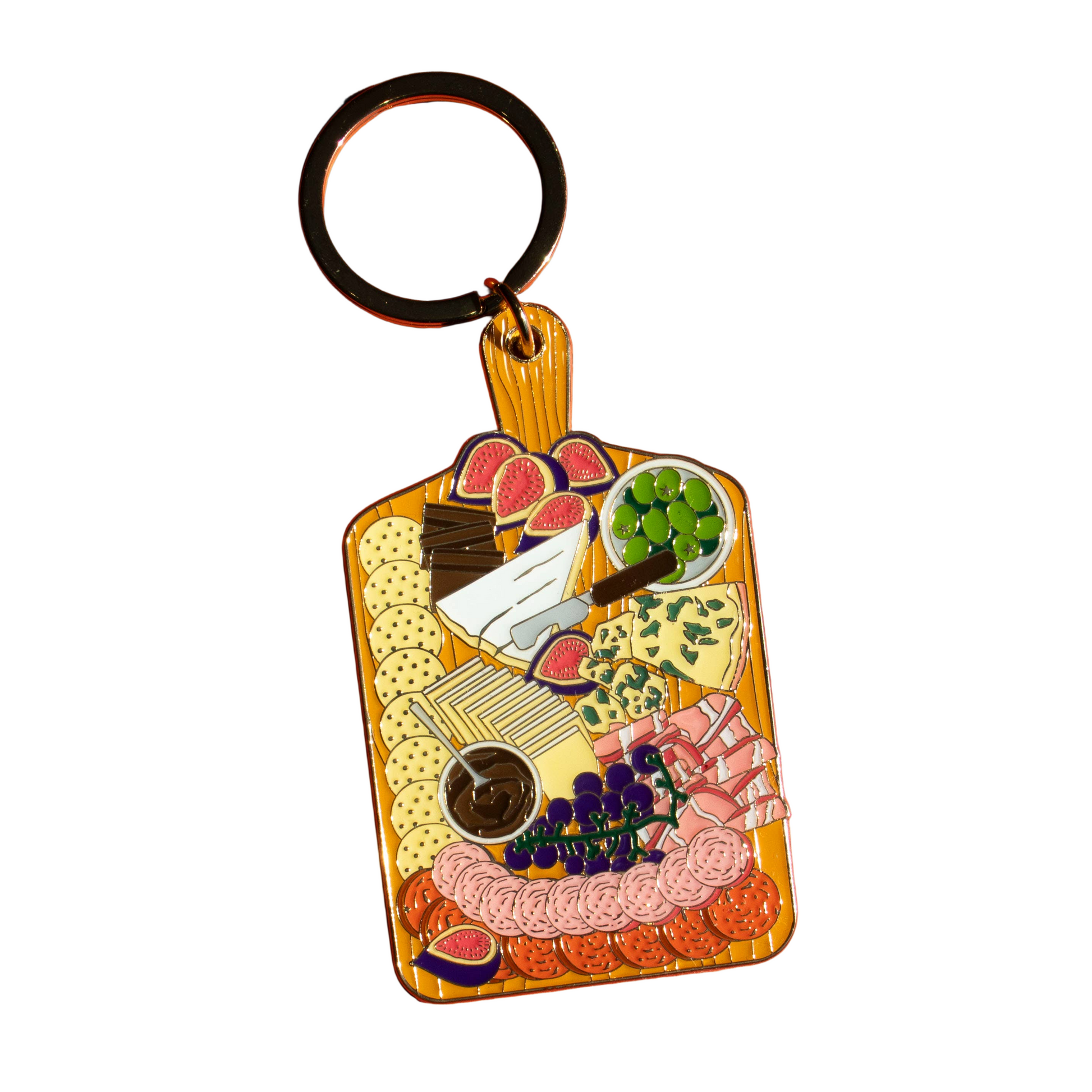 Keychain shaped like a charcuterie board with various food items on a white background