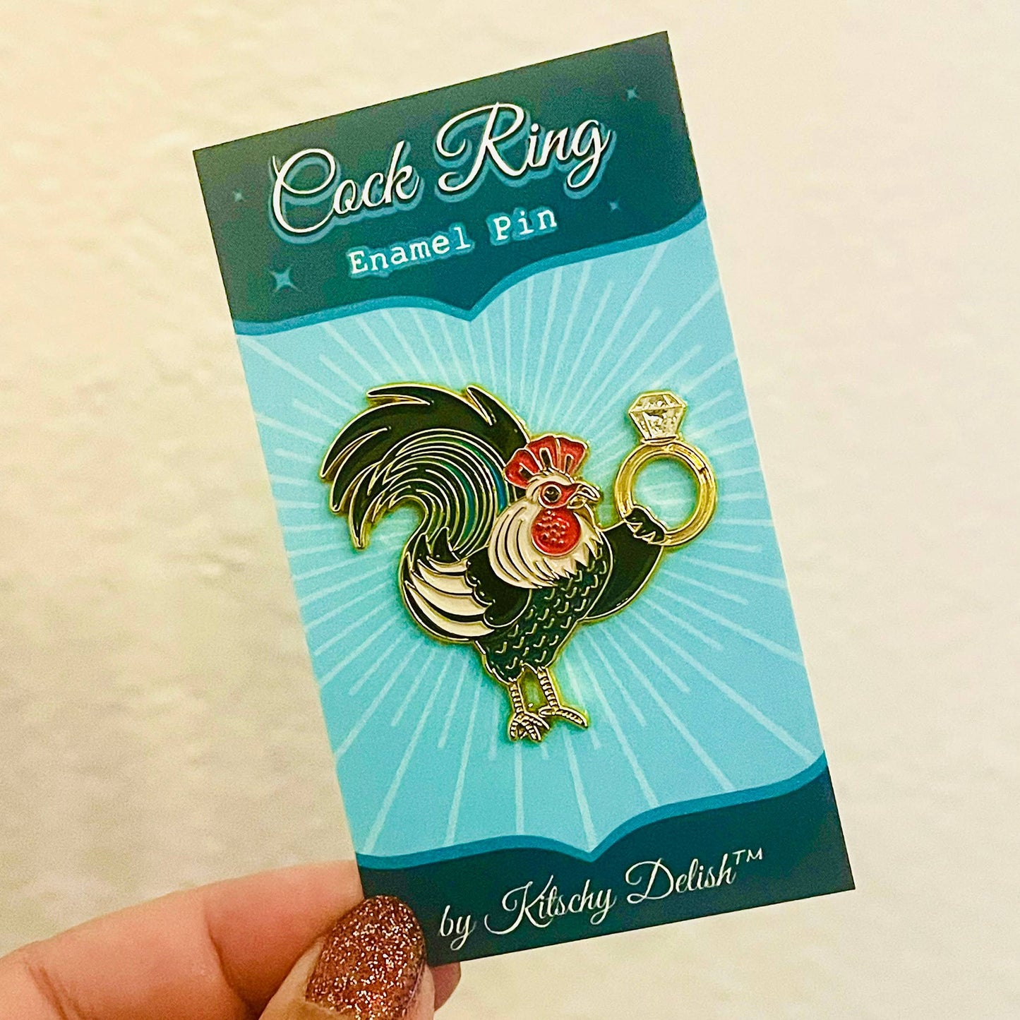 Cock Ring Enamel Pin packaging with a rooster design