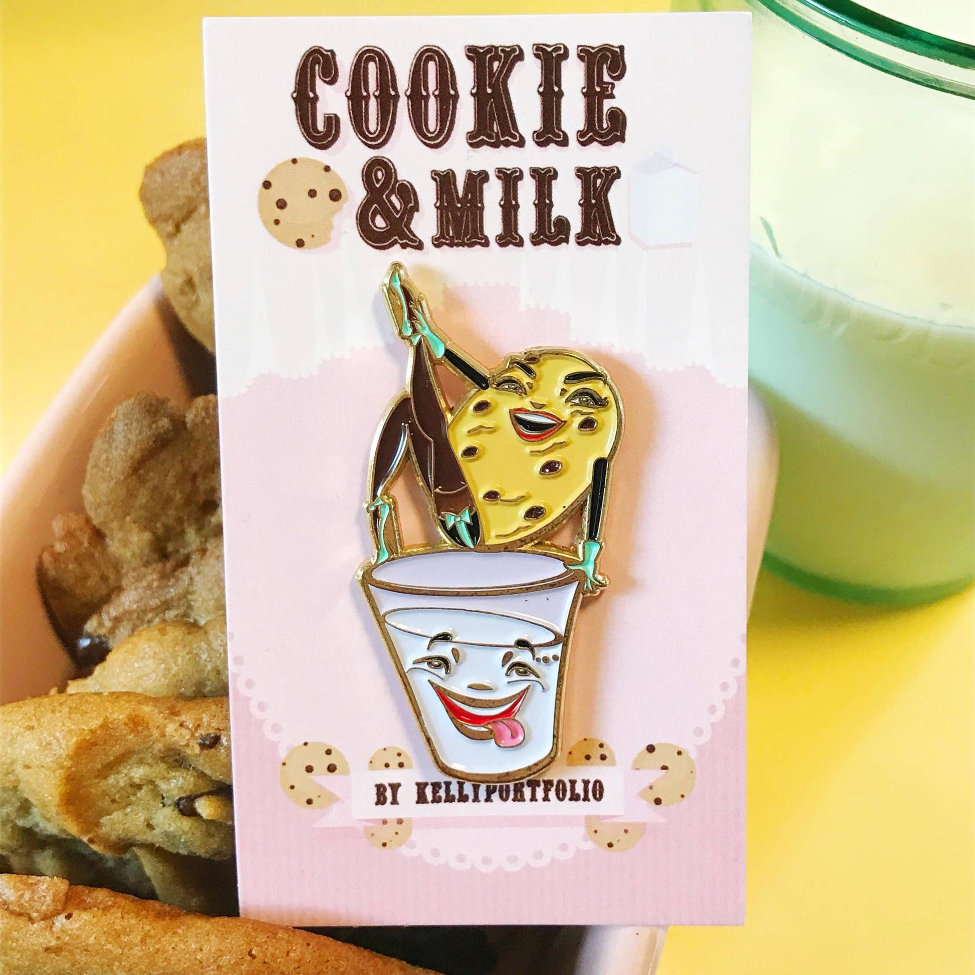 Enamel pin of a milk with a cookie on top, surrounded by cookies and a glass of milk.