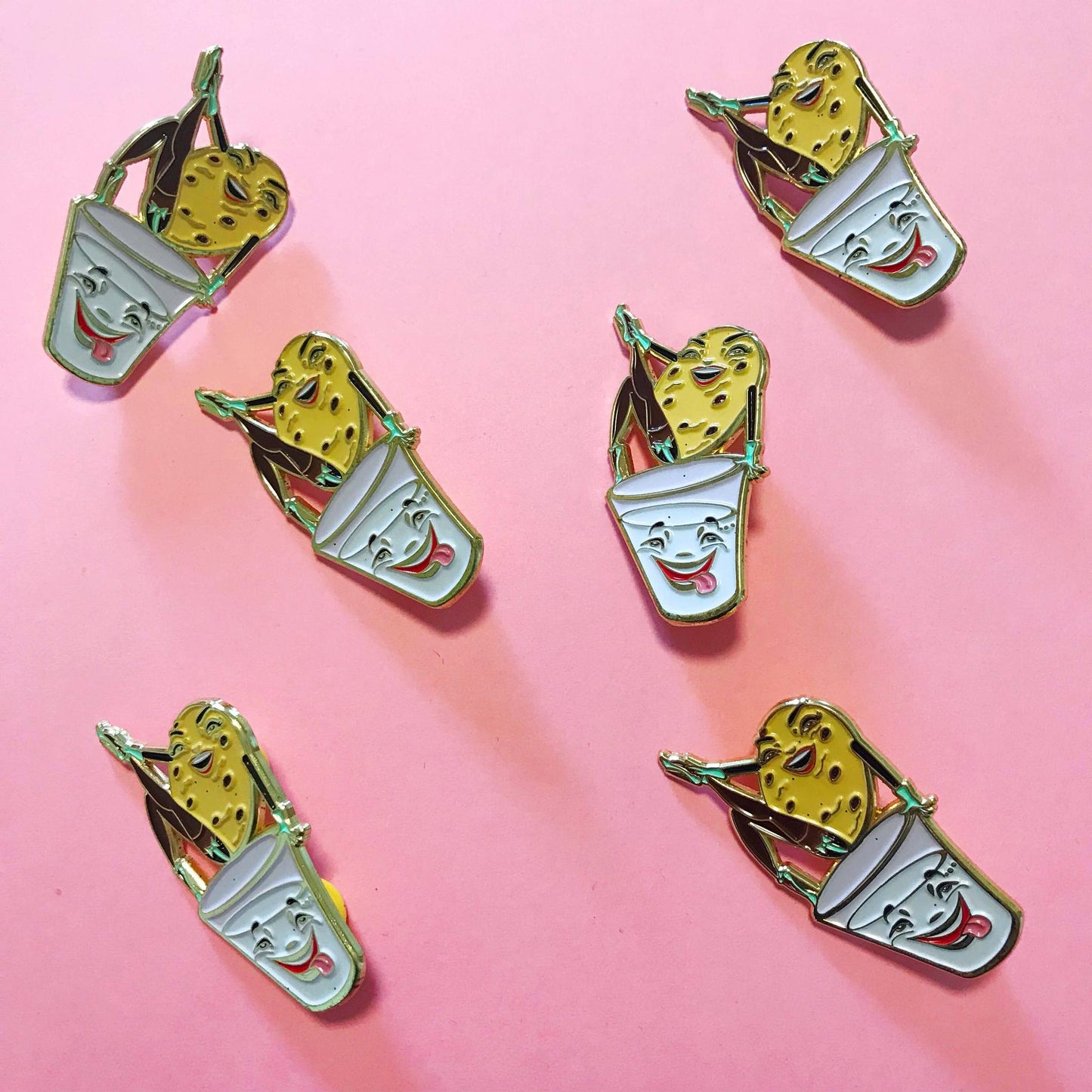 Colorful cookie and milk pins on a pink background