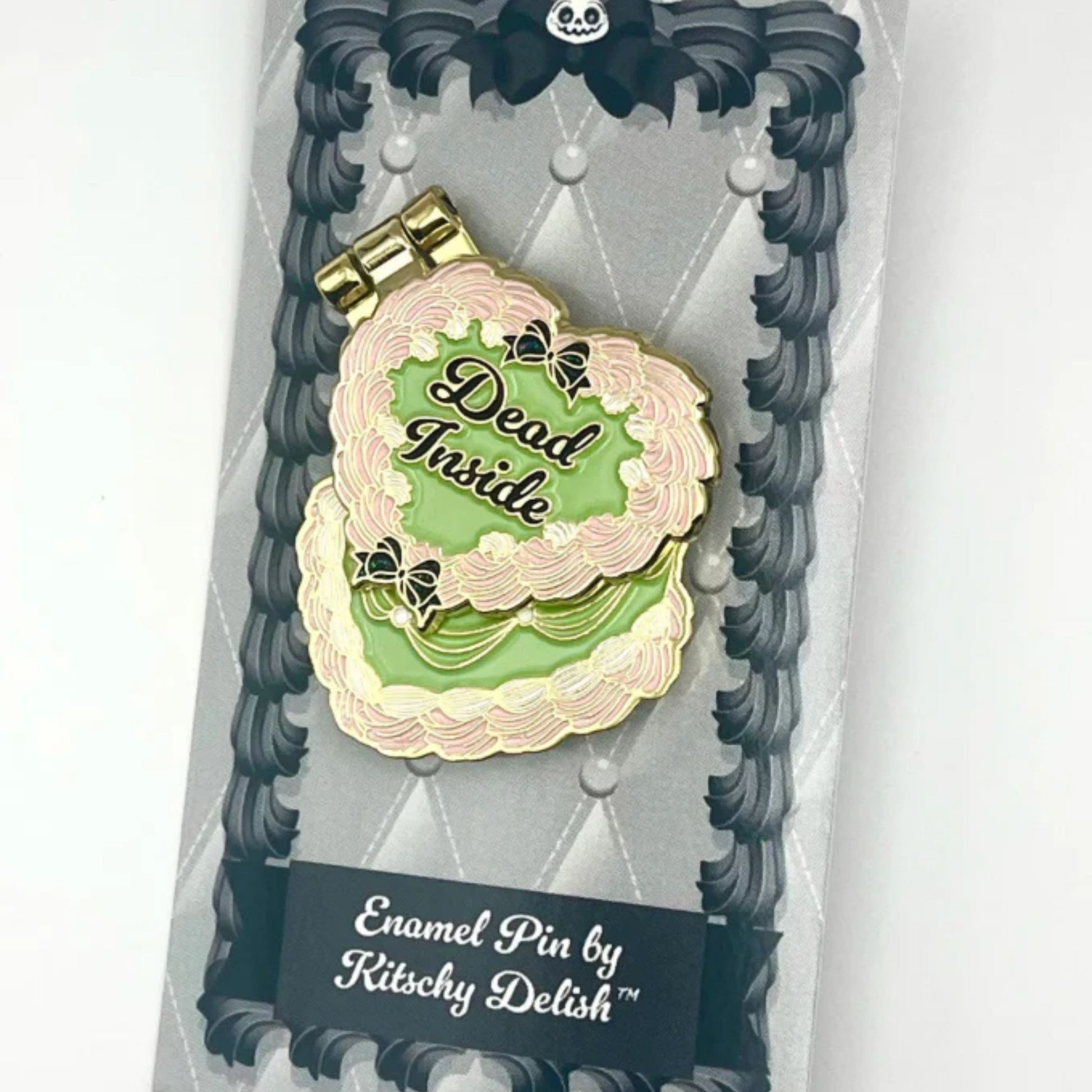Enamel pin with 'Dead Inside' design on a decorative card, brand 'Kitschy Delish' visible
