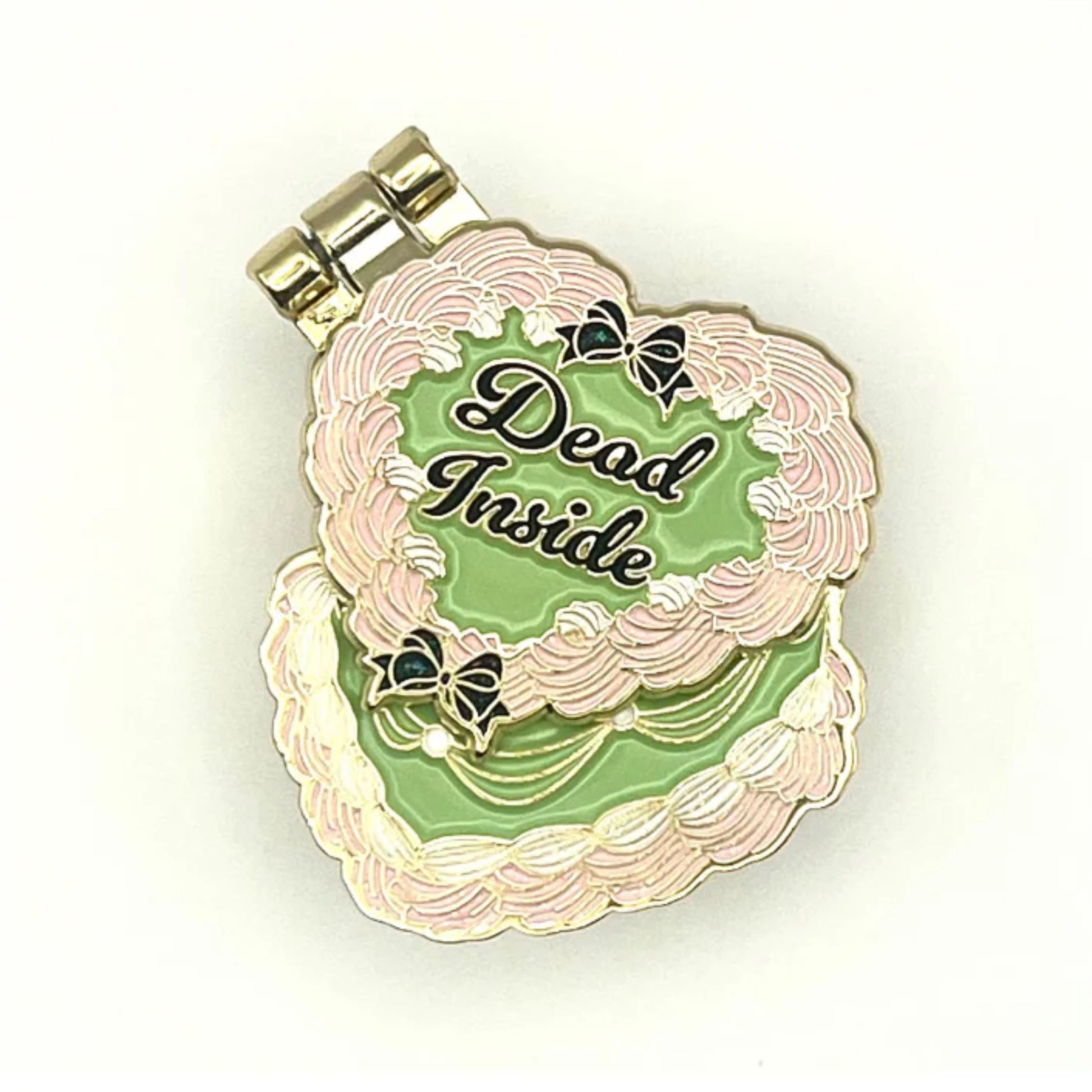 Enamel pin with 'Dead Inside' text on a green and pink background