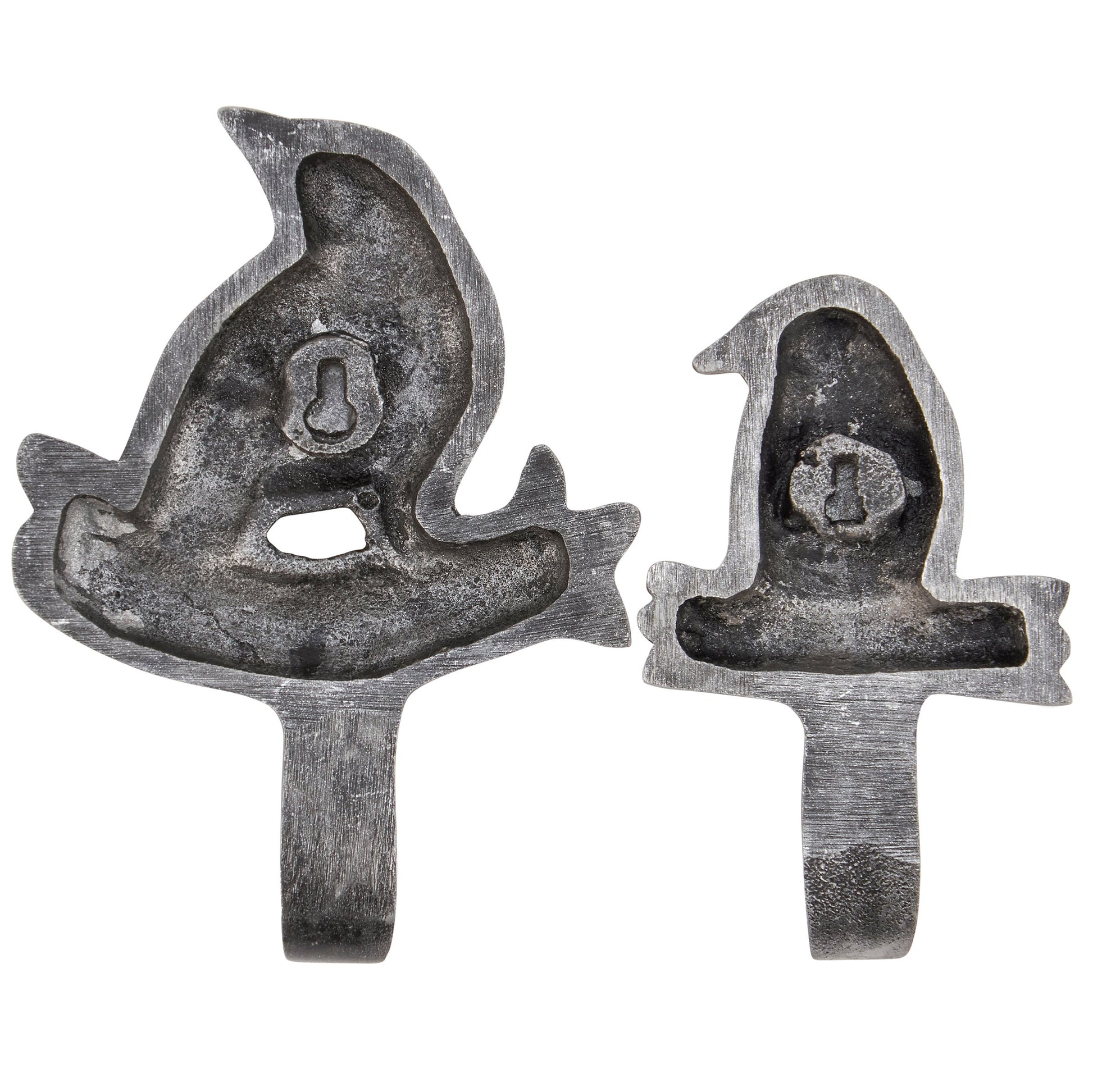 Back of two metal tools with a bird design