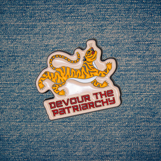 Patch with tiger design and 'Devour the Patriarchy' text on denim fabric