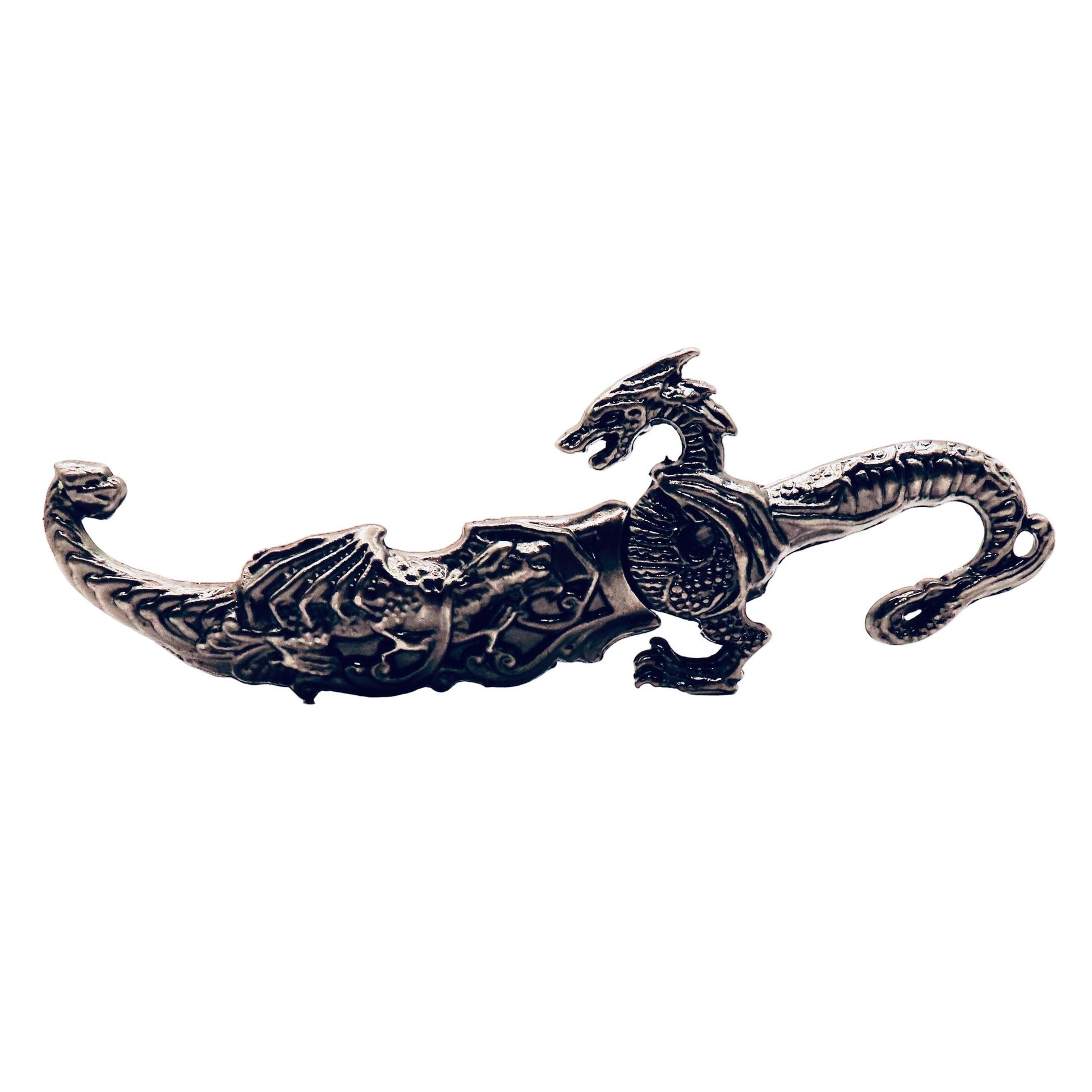 Decorative metal object with dragon design on a white background