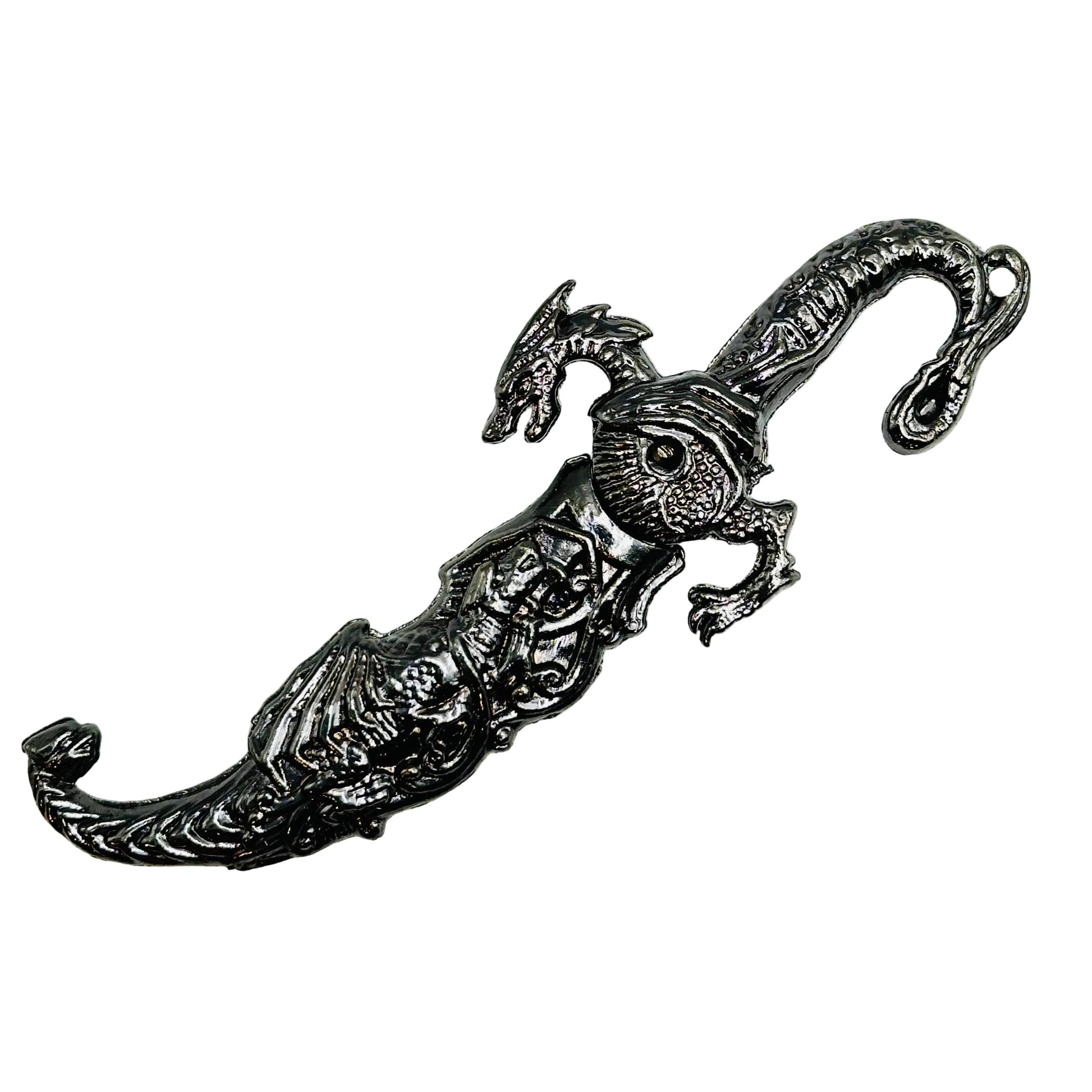 Decorative silver dagger style letter opener with intricate dragon designs on a white background