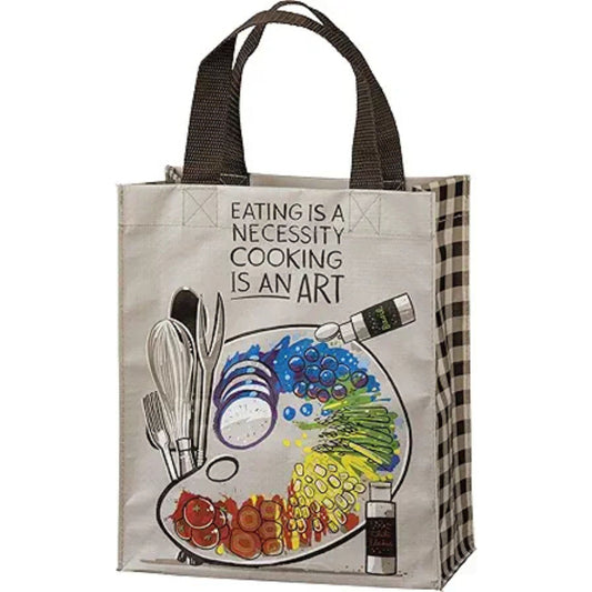 Tote bag with kitchen utensils and food illustration, featuring the quote 'Eating is a necessity, cooking is an art'.