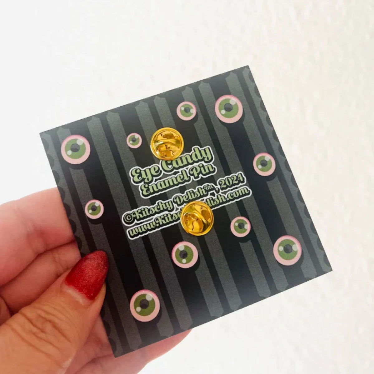 Back part of an enamel pin on a black card