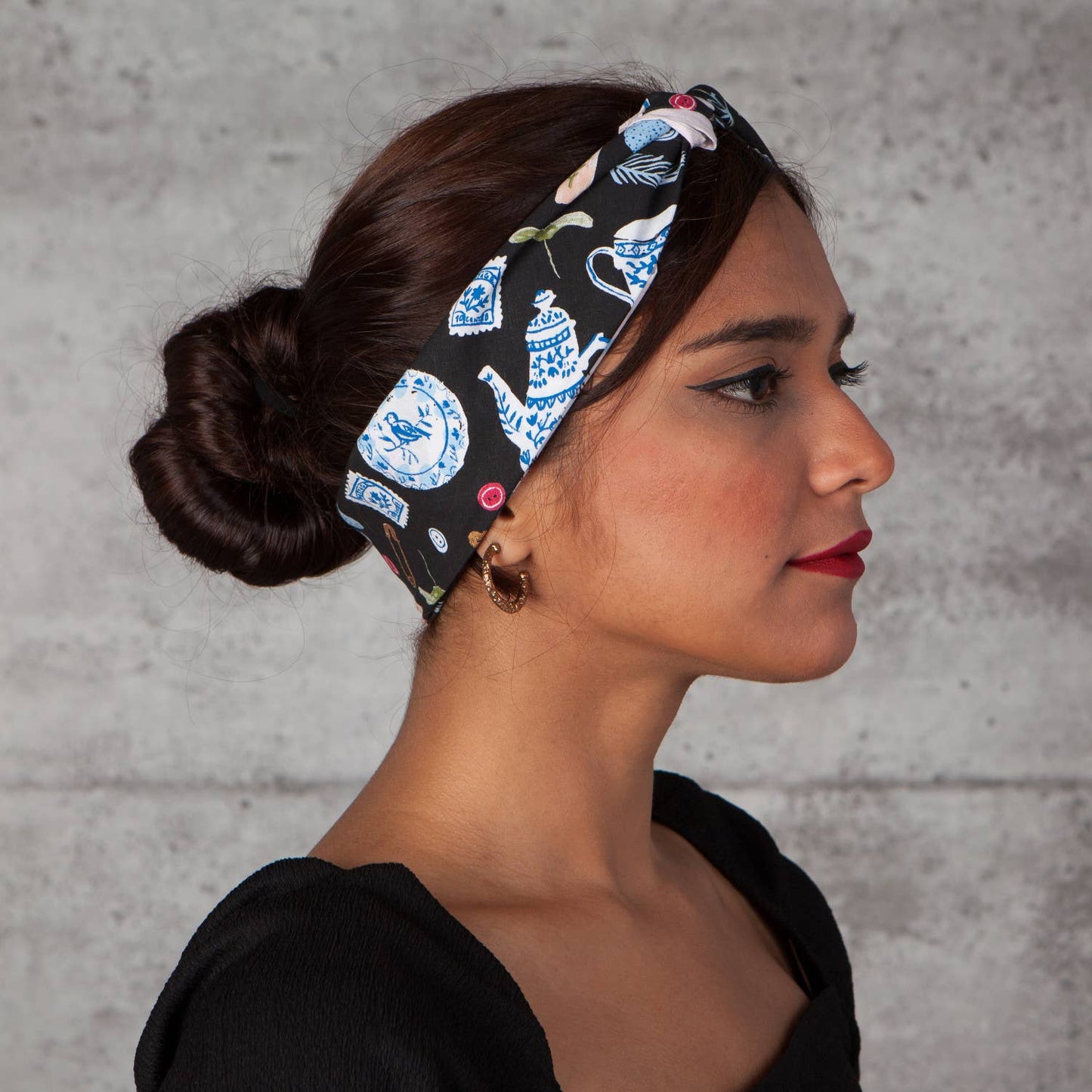 Woman wearing a patterned teapot bandana