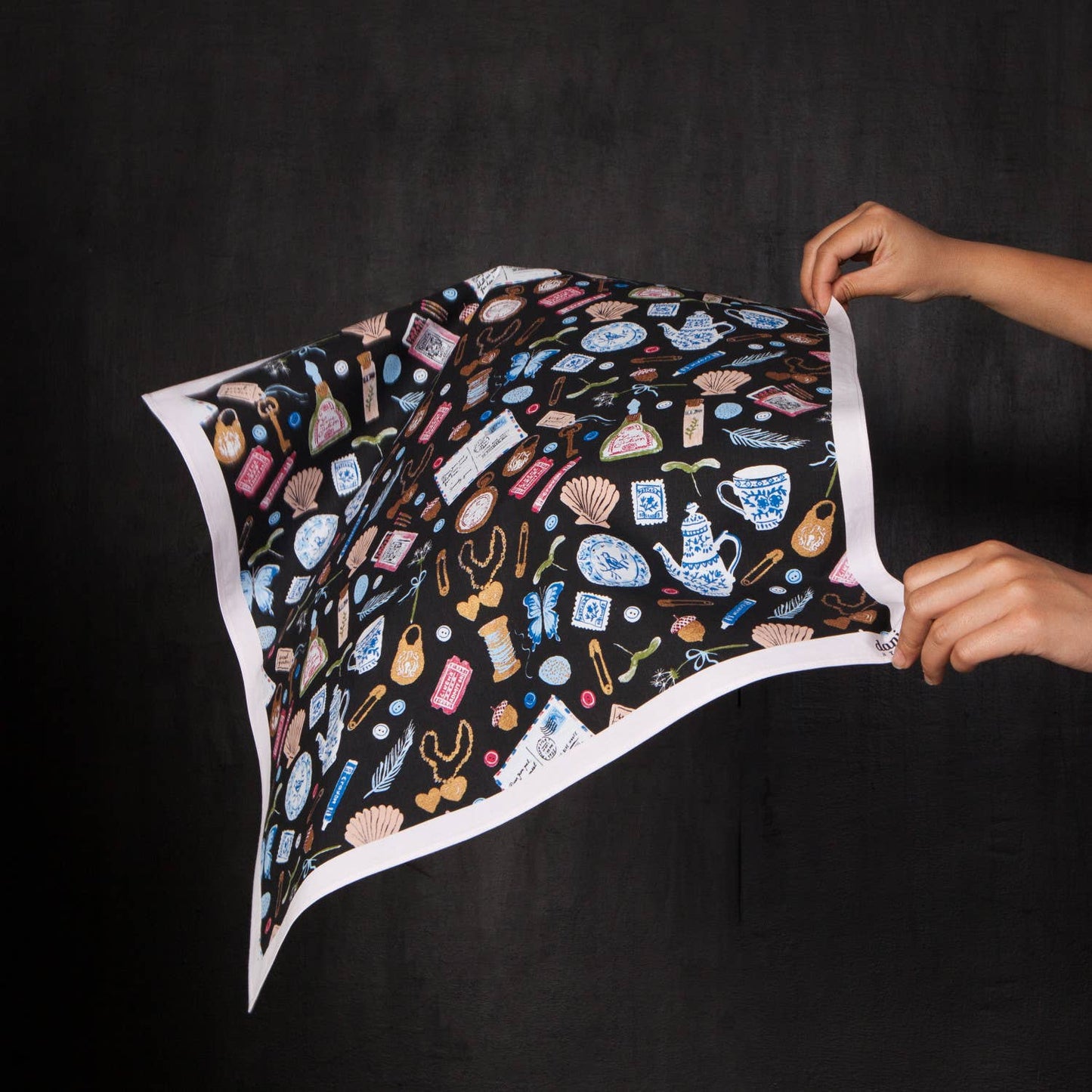 Person holding a colorful patterned bandana
