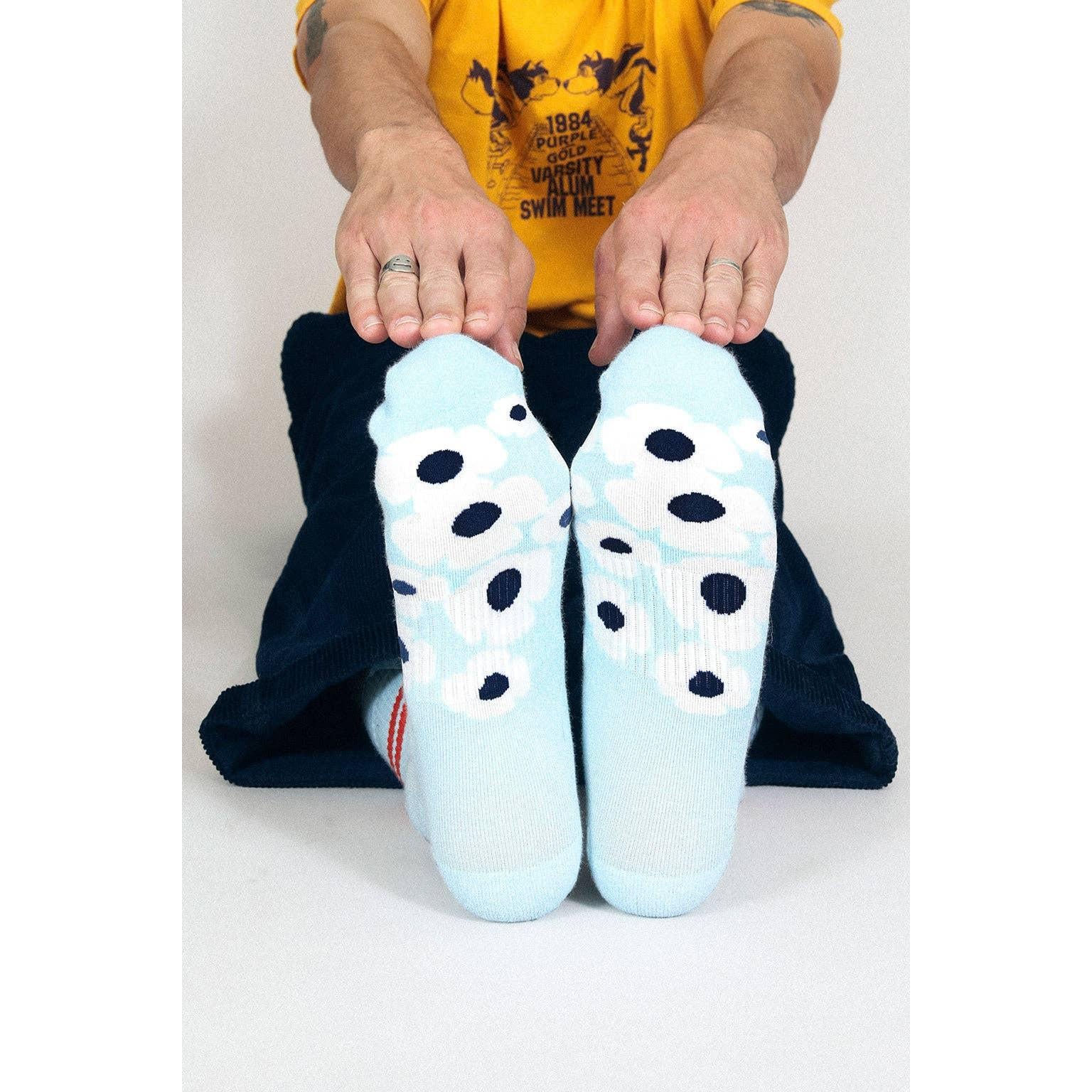 Person wearing light blue socks with white flowers design