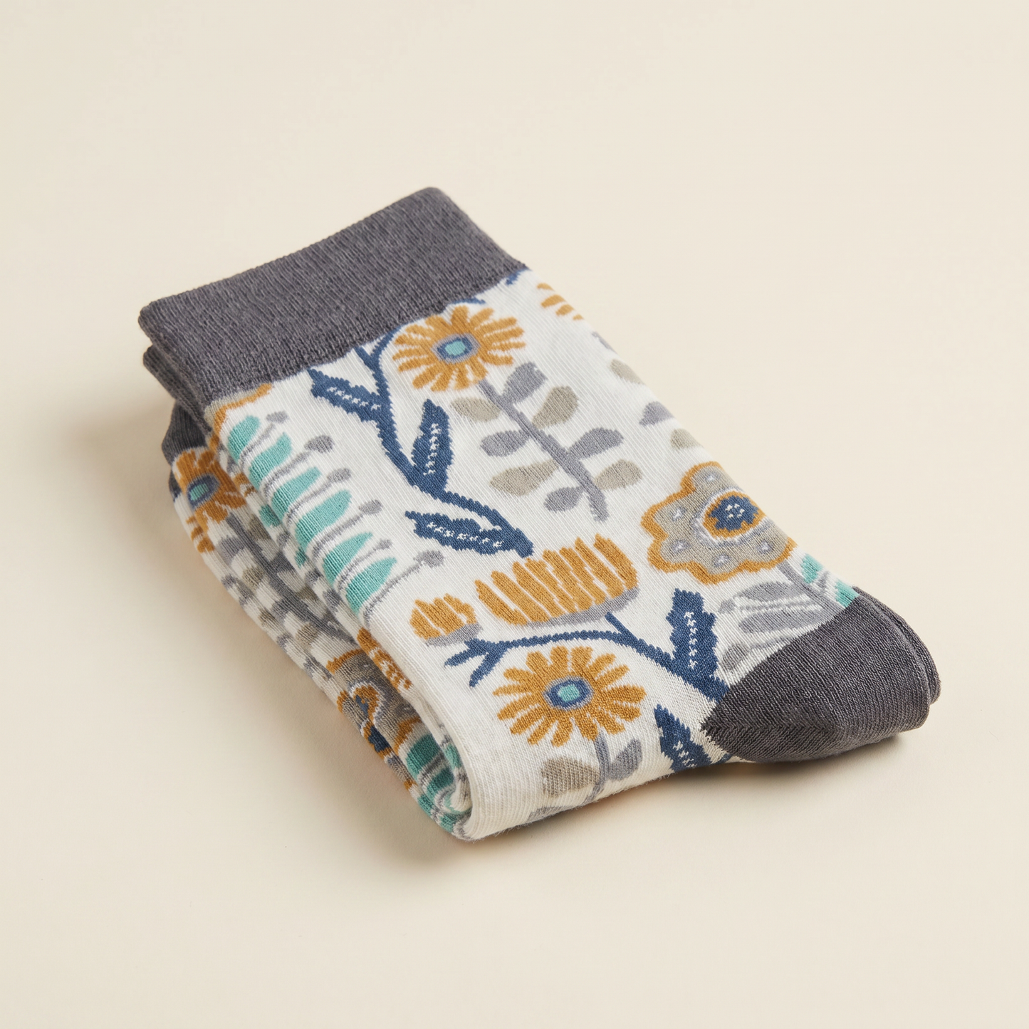 Stack of floral-patterned socks on a beige background
