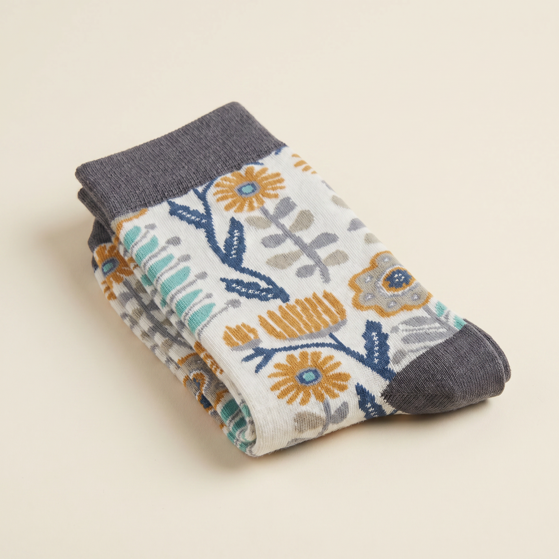 Stack of floral-patterned socks on a beige background