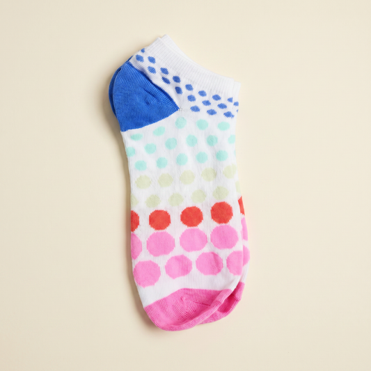 Colorful polka dot sock on a beige background