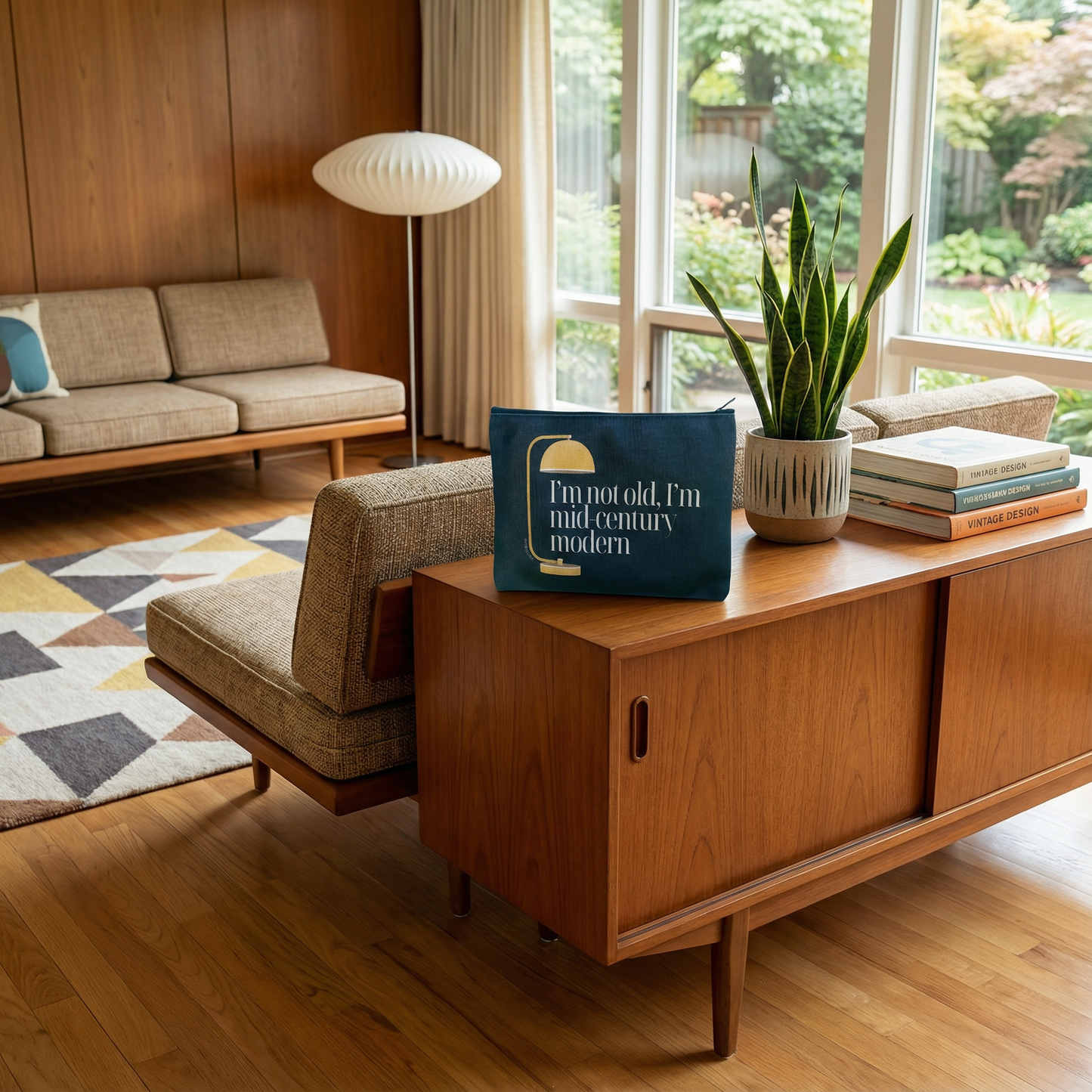 Modern living room with wooden furniture, a plant, and a decorative pillow.