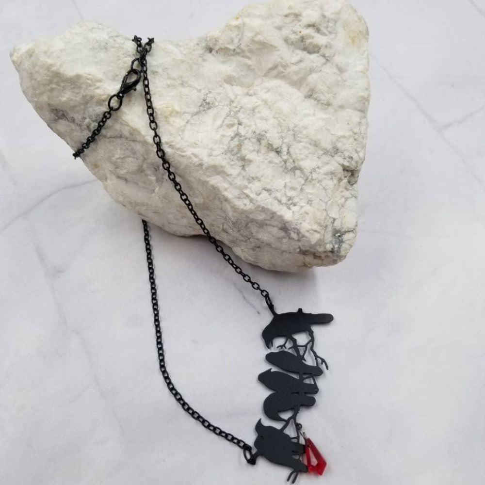 Black necklace with raven pendant