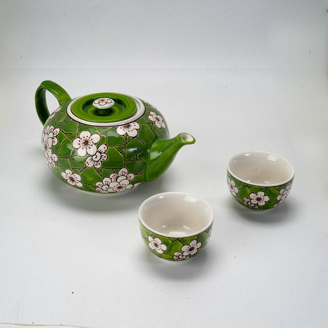 Ceramic teapot and two cups with floral design 