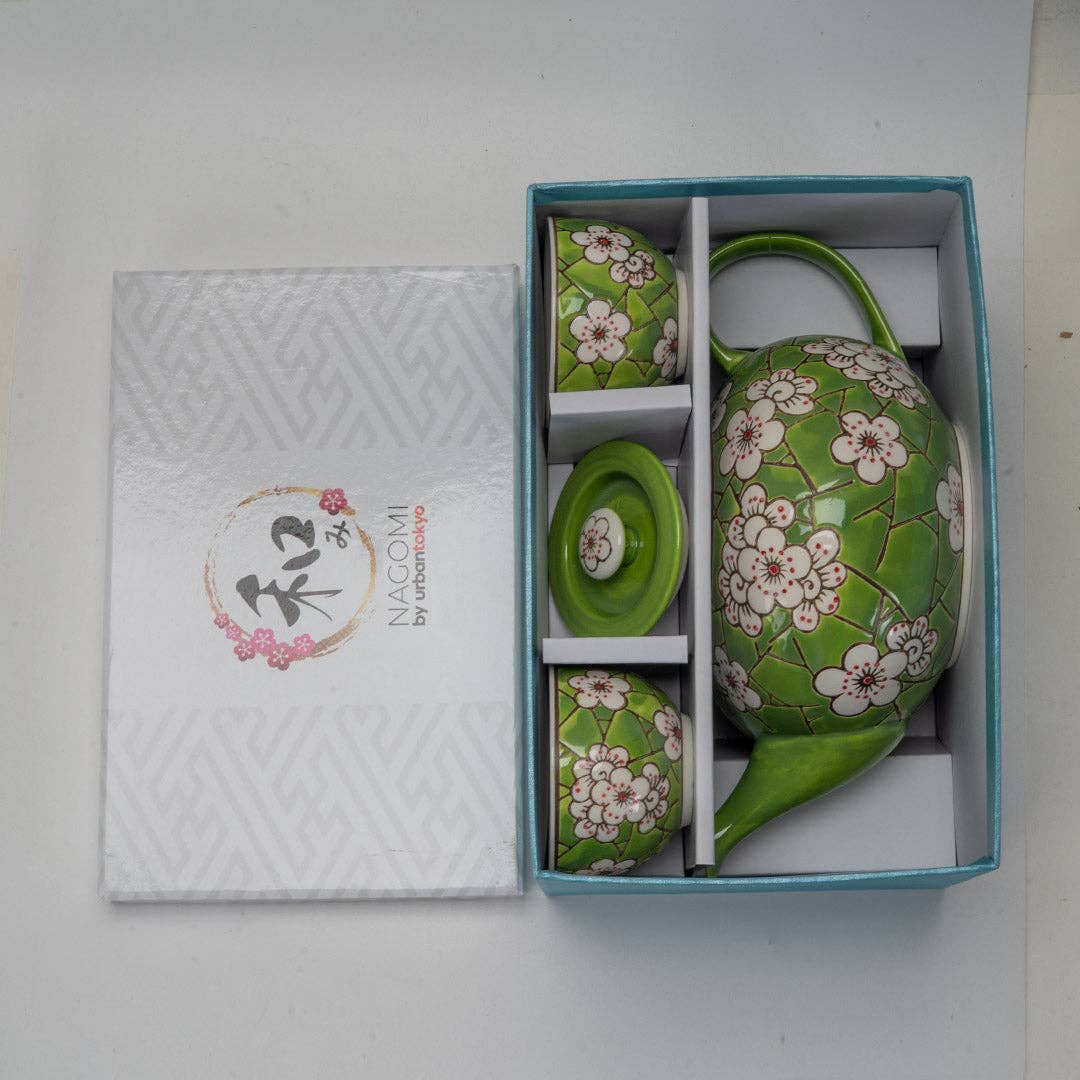 Green ceramic tea set with floral patterns in a box
